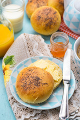 Buns rolls with poppy seeds with butter for breakfast