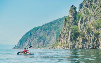 Mеn kayaking on Lake Baikal. Landscape. Siberia.