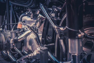 Detail of the engine and mechanics of an old motorcycle. Conceptual photo with vintage retro colors.