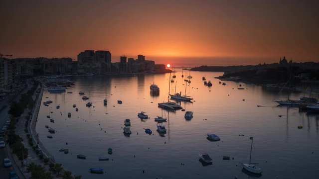 Time lapse of a runrise at marina with boats and buildings in Valletta, Malta. 4K UHD HDR 422 10 bit ProRes 