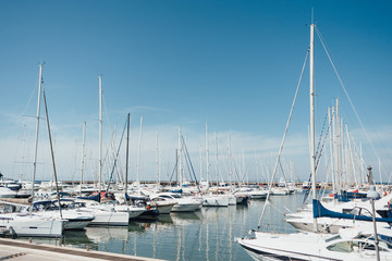 Naklejka na ściany i meble Yacht parking in harbor, harbor yacht club in Marina di Scarlino, Italy. Beautiful Yachts in blue sky background