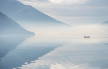 Fisherman going to fishing during fog in morning