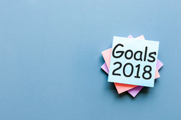 2018 goals on paper note background and empty space for text, mock up, business and new year concept