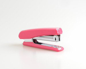 Pink stapler isolated on a white background