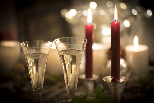 Festive new years eve candlelight scenery with glasses of sparkling champagne