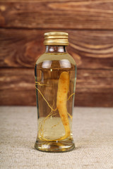 Glass jar of ginseng essence isolated on table
