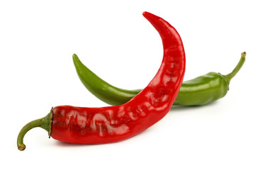 Green and red hot chili peppers close up on white