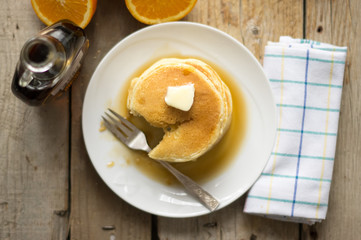Small homemade pancakes on the wooden table, top view