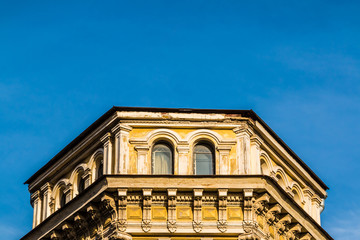 Obraz premium Low angle view of the attic of the urban historic building on the background of clear sky, Saint Petersburg, Russia 
