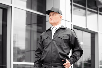 Male security guard standing outdoors