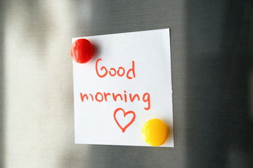 Note with words "Good morning" on refrigerator door © Africa Studio