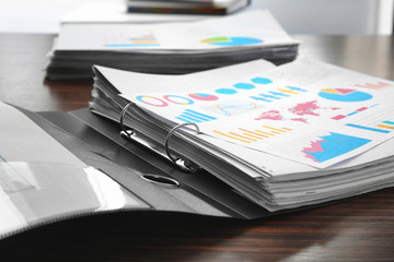 Folder with documents on table
