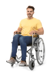 Young man in wheelchair on white background