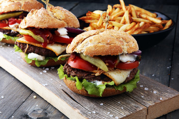 fresh tasty burger and french fries on wooden table