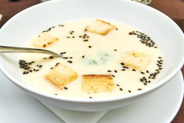 Delicious cream soup with bread on table