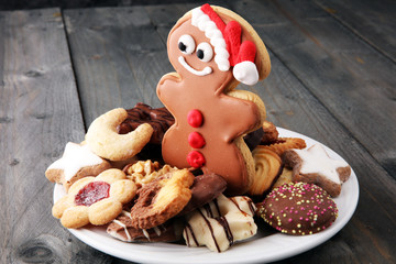 Santa claus cookie and Plate with tasty fresh Christmas cookies on  table