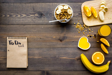 Good morning habits. Eat porridge and fruits and make to do list. Dark wooden background top view copyspace
