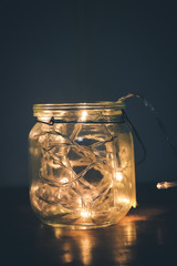 Glass jar with yellow lights