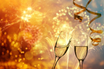 Champagne glasses on sparkling background