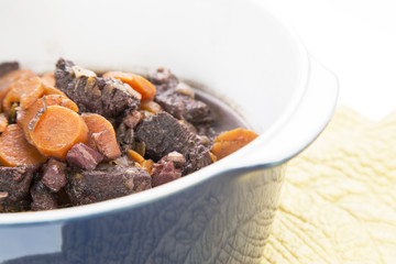 Beouf Bourguignon stew in a blue casserole dish
