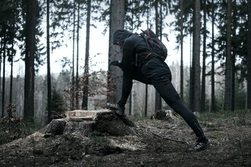 Obraz premium Runner stretching legs in the forest