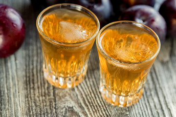Plum brandy or slivovitz with fresh and tasty plum