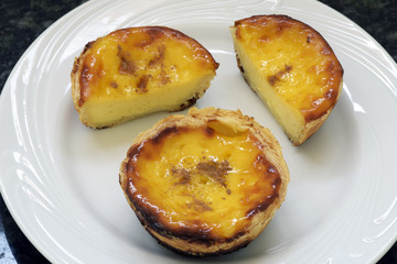 Close-up of pasteis de Belem in white plate