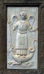 Bas-relief of an angel at the entrance of a church in Cortona, Italy