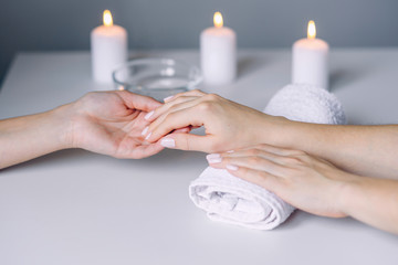 Obraz na płótnie Canvas Manicurist hands doing massage from female client's hands. Woman hand receiving manicure procedure. Spa salon. Beautiful woman hands having nail treatment procedure.