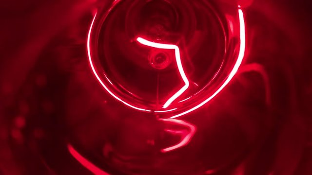 Red party light turned on and off in rhythm of the music. Closeup footage of blinking green disco light bulb.