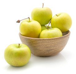 Apples (Smeralda variety) in a wooden bowl isolated on white background green yellow.