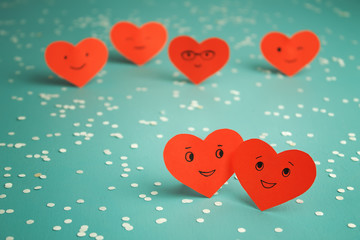 Many red smiling hearts on a blue background. St. Valentine's Day. Couple in love.