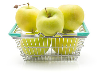 Apples (Smeralda variety) in a shopping basket isolated on white background green yellow with blush.