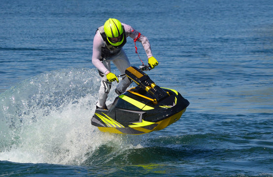  Freestyle Jet Skier performing 360  creating at lot of spray.