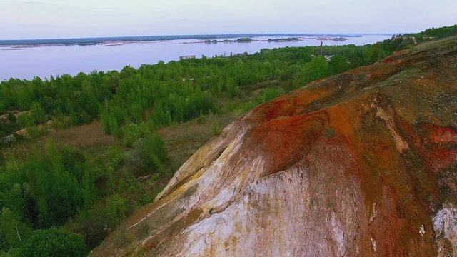 4K aerial landscape with multicolored rock dumps from quarries, Flying over the quarry rocks, fly above the quarry, Top view of the sandy dolomite quarry