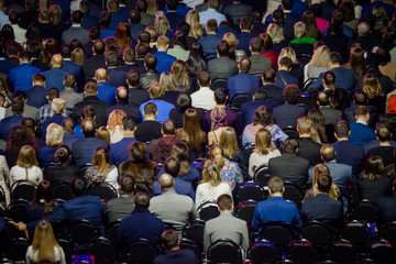 People attend business conference in the congress hall