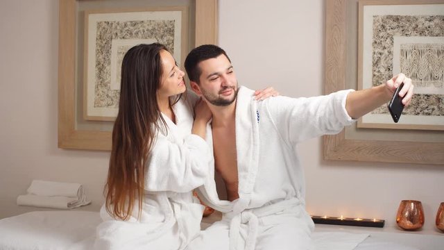 Attractive young couple makes a selfie in Spa Center.