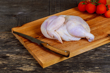 Raw chicken part of the on the wood board for marinating