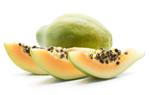 Green papaya (pawpaw, papaw) one whole three slices with seeds isolated on white background.