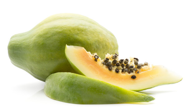 Green papaya (pawpaw, papaw) one whole two slices isolated on white background.