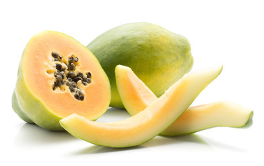 Green papaya (pawpaw, papaw) one whole one half and two slices without seeds isolated on white background.