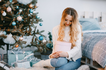 pretty blonde woman opening presents