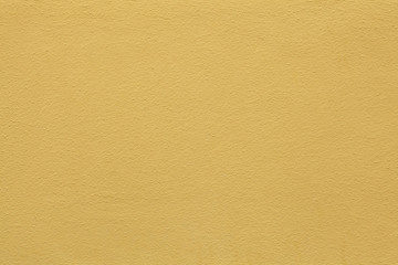 Yellow painted stucco wall. Background texture