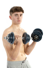 Fototapeta na wymiar 18 Year old teenage boy lifting weights