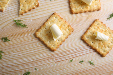 Cracker with butter on a wooden background