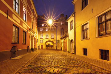 The Swedish Gate, part of the ancient Riga Wall, and typical europeen medieval street at night, Riga, Latvia