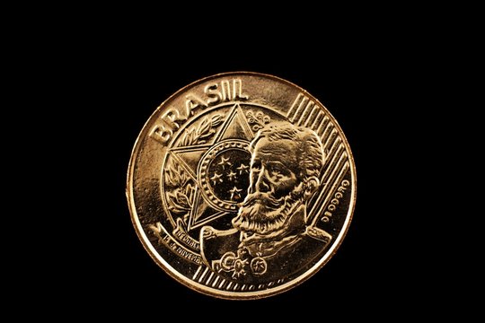A super macro image of a 25 centavo Brazilian coin isolated on a black background