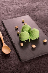 Pistachio ice cream on rustic wooden board