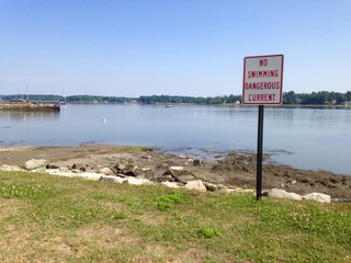 no swimming sign at the ocean 