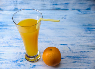 oranges and orange juice on a wooden light background